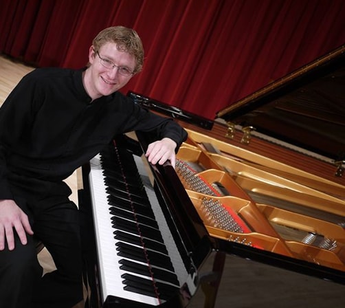 Rory Sitting by Piano